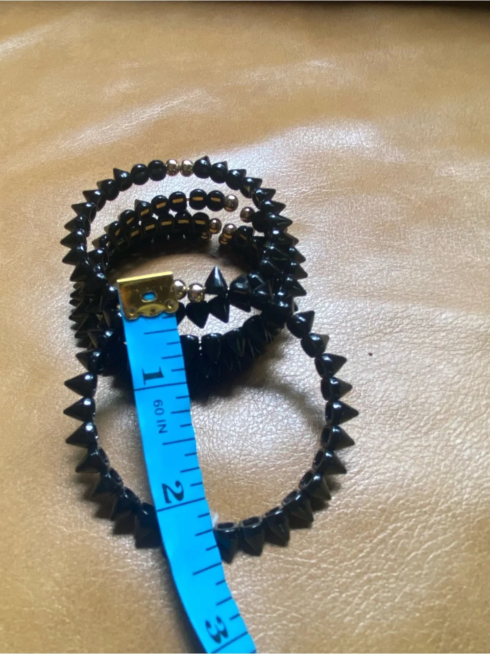 Black spike stacking bracelets with gold accents